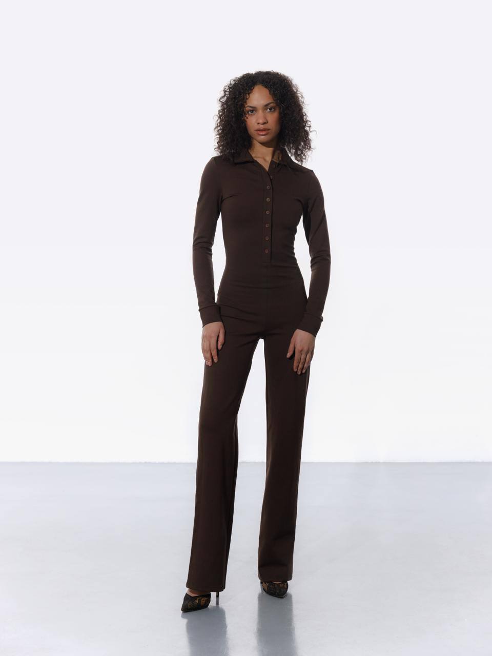 Woman wearing classic brown tailored jumpsuit with straight-leg cut